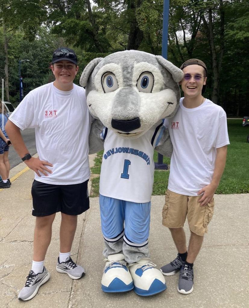 Two TKE members pictured with Woody the Timberwolf